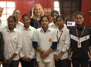 The Chief Examiner with a dozen young female students in a school in India