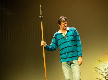 LAMDA's Head of Drama School, Rodney Cottier, on stage with a prop