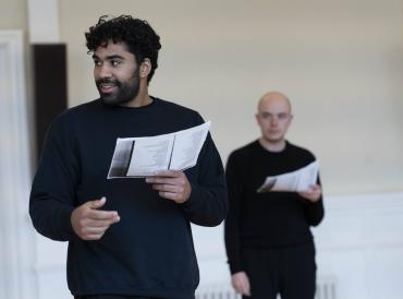 Student with script smiling in rehearsals