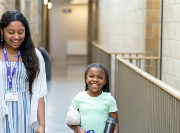 A learner walking down the LAMDA corridor