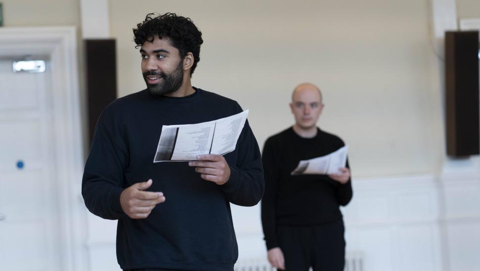 Student with script smiling in rehearsals